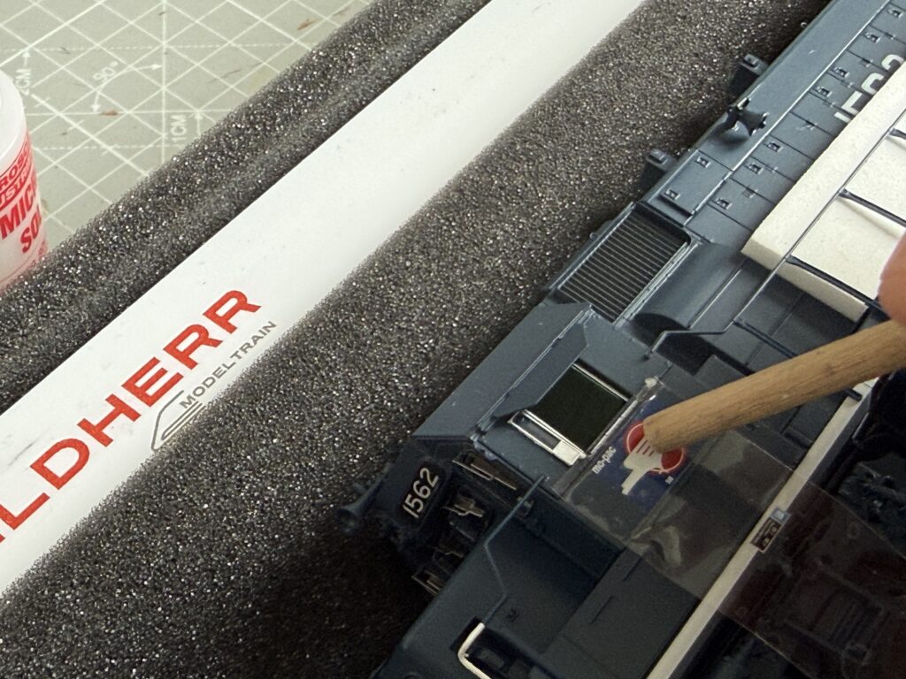 Pressing the tape over the logo