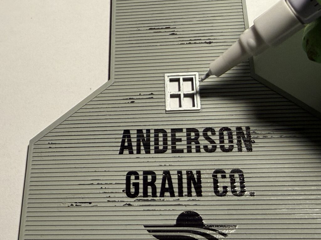 Painting the window frames with a paint marker