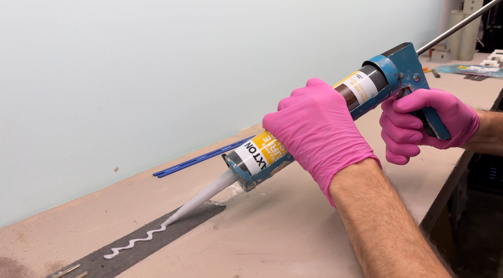 Laying caulk to glue tracks