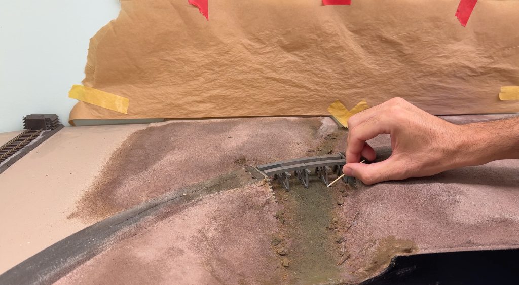 Bridge scenery: glueing the bridge in place.