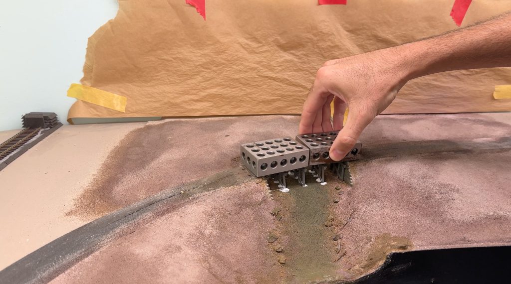 Adding weight to the bridge while the glue dries.