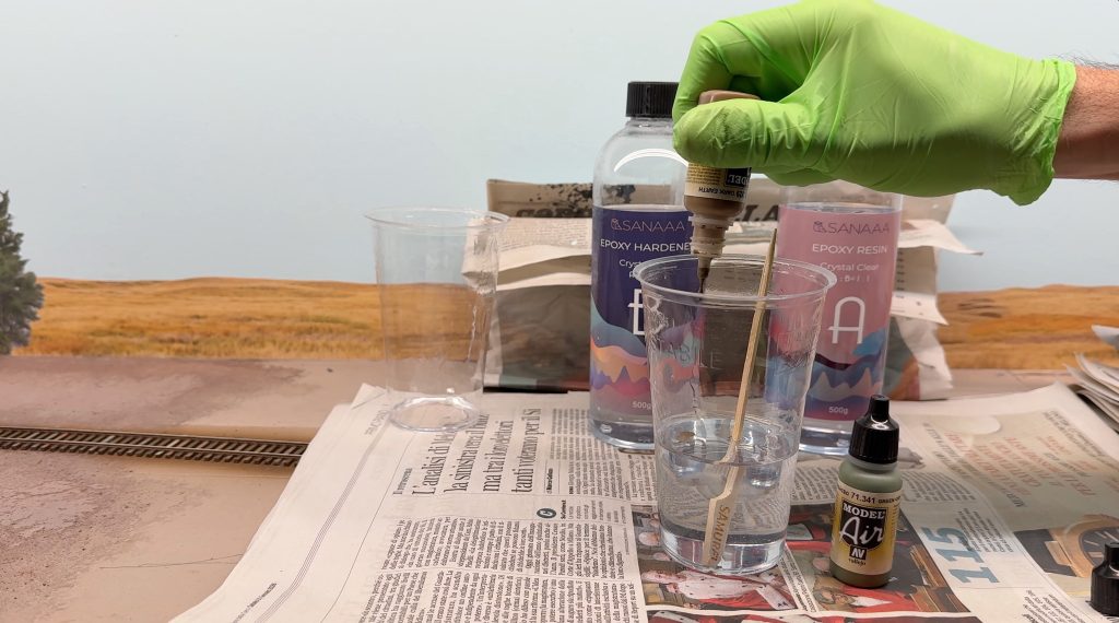 Adding few drops of brown and green paint to the resin