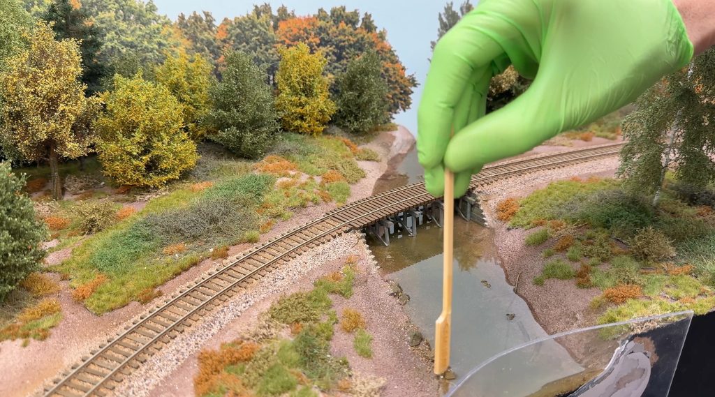 Carefully distributing the resin along the river banks