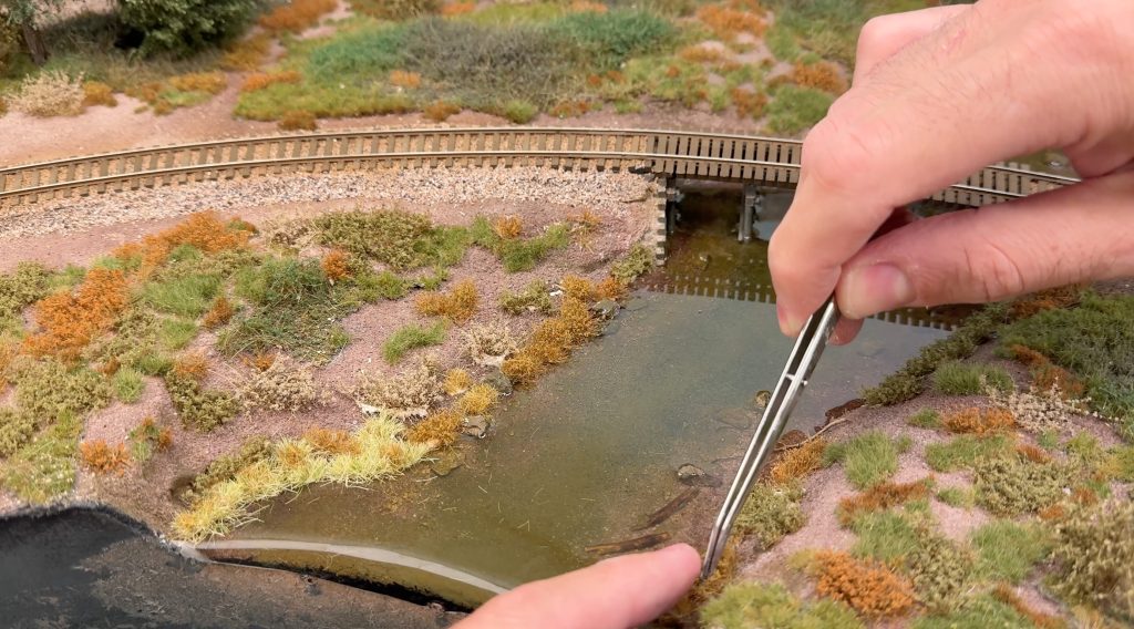Adding Martin Welberg tufts and weeds along the river banks